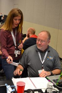 Angie Asmus discusses plans for wifi with SCinet edge team lead, Benny Sparks.